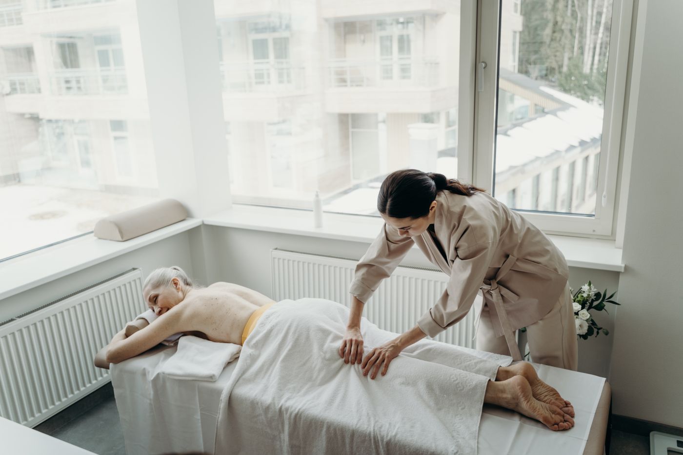 Therapist giving a massage on a portable table at home in Dubai