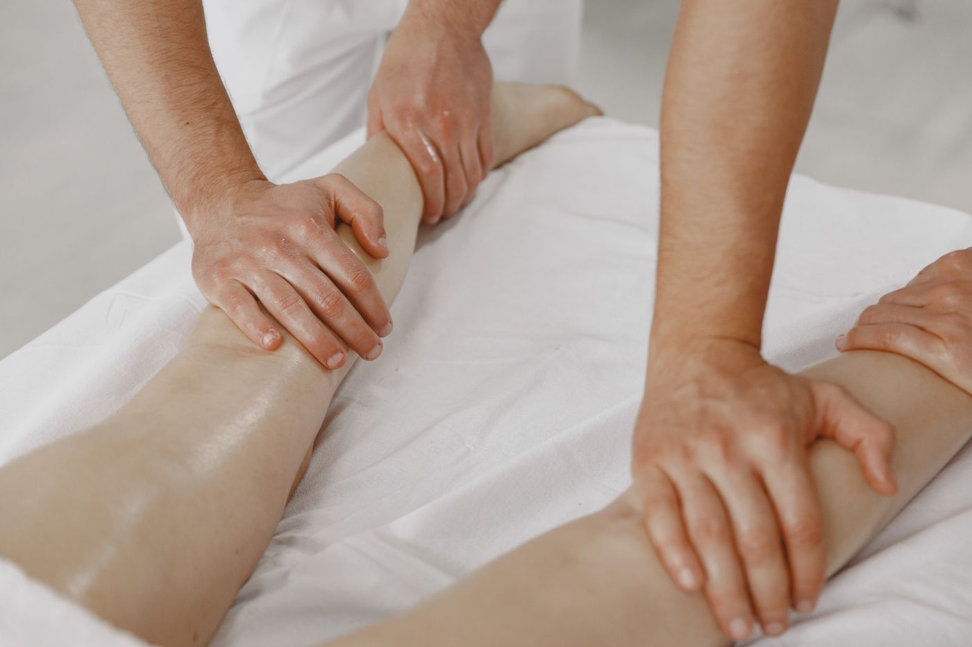 Light strokes along the leg in a lymphatic drainage massage in Dubai