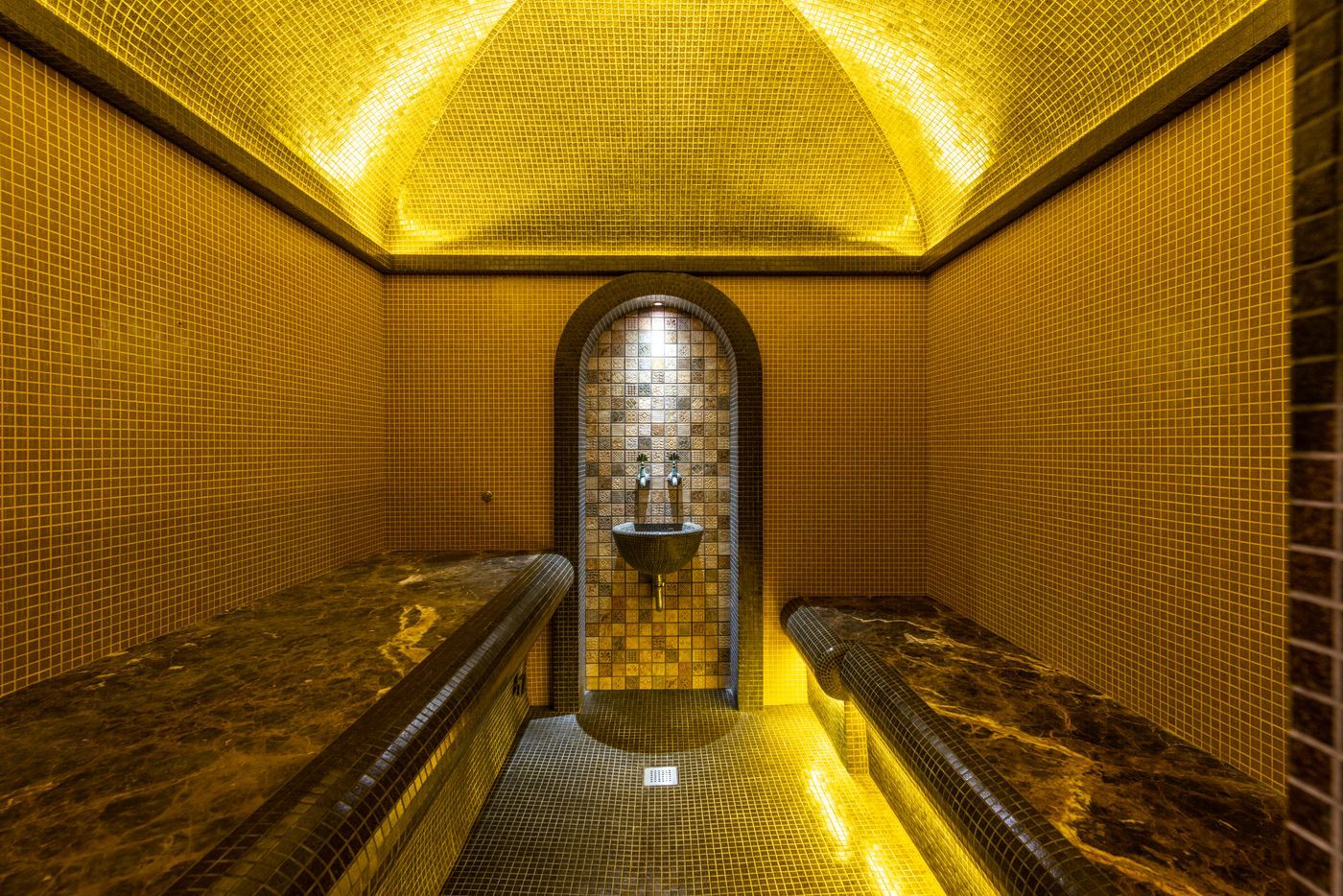 Mosaic hammam room with marble benches for a Moroccan bath in Dubai