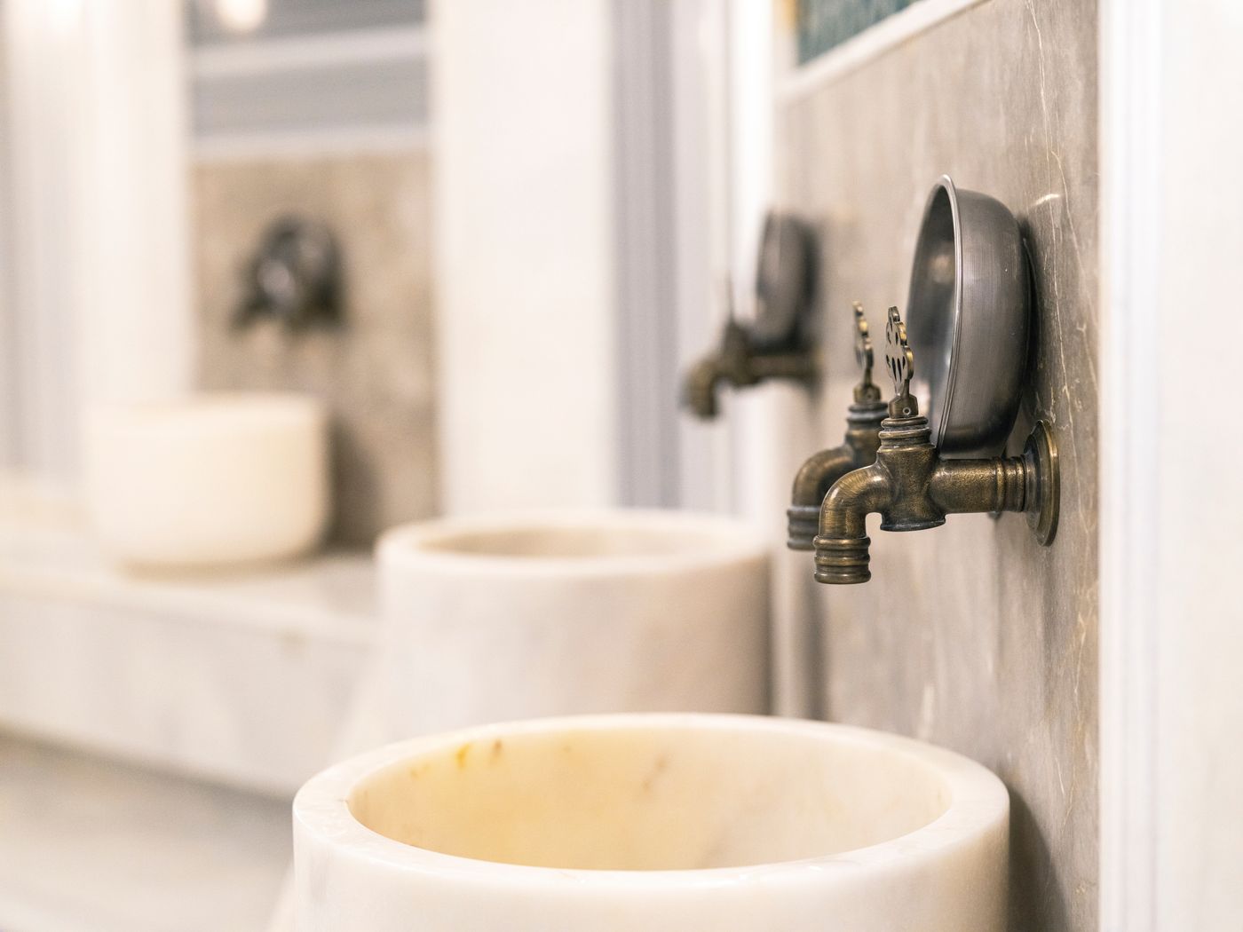 Marble basins and traditional taps in a Turkish bath hammam in Dubai